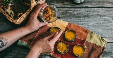 person holding clear glass container