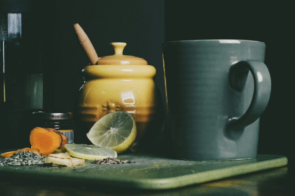 Soluciones Naturales para el Día a Día 1 beige ceramic jar beside grey ceramic pitcher and sliced lemon fruit